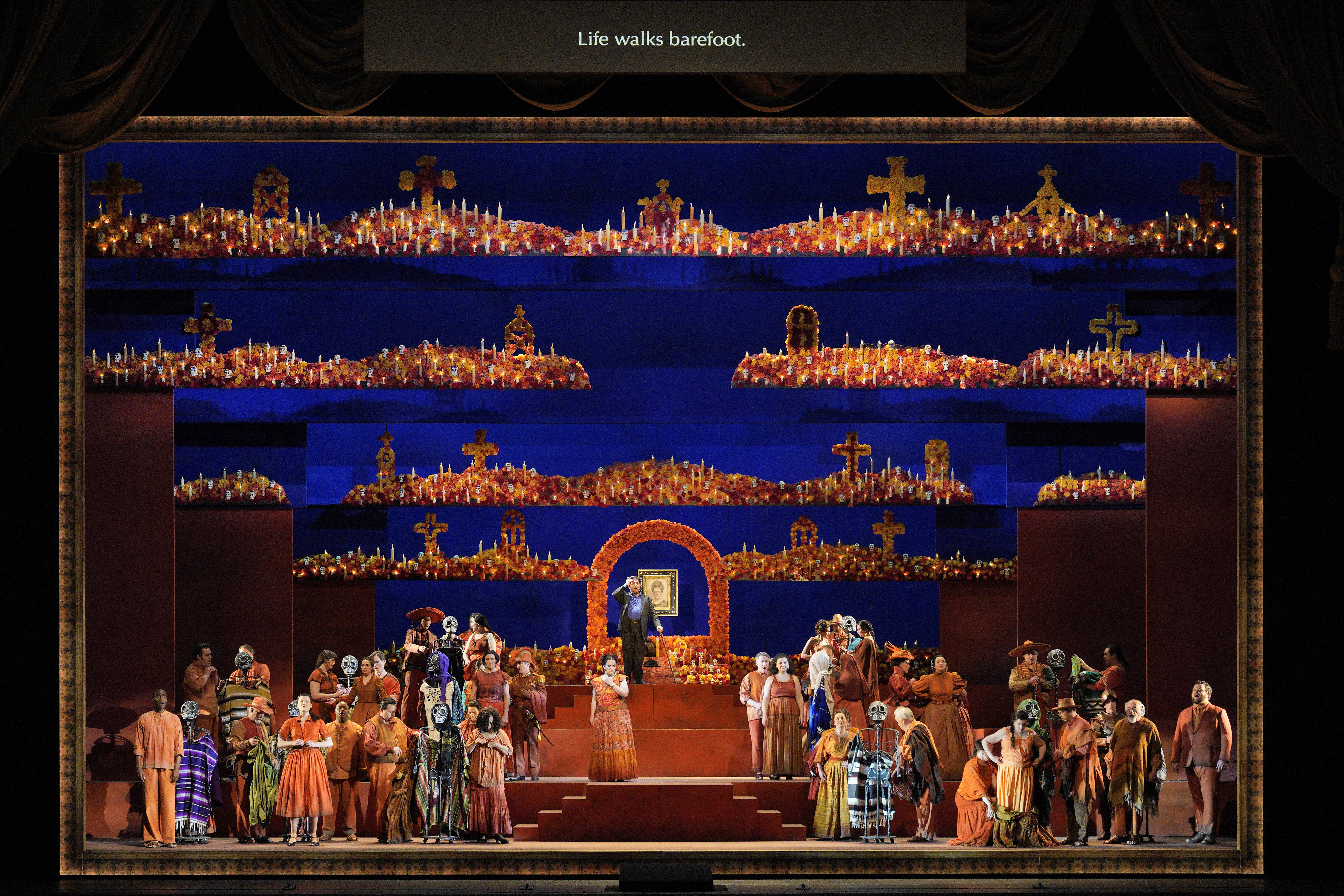 Scene from Frida of stage set with a large number of people on stage 