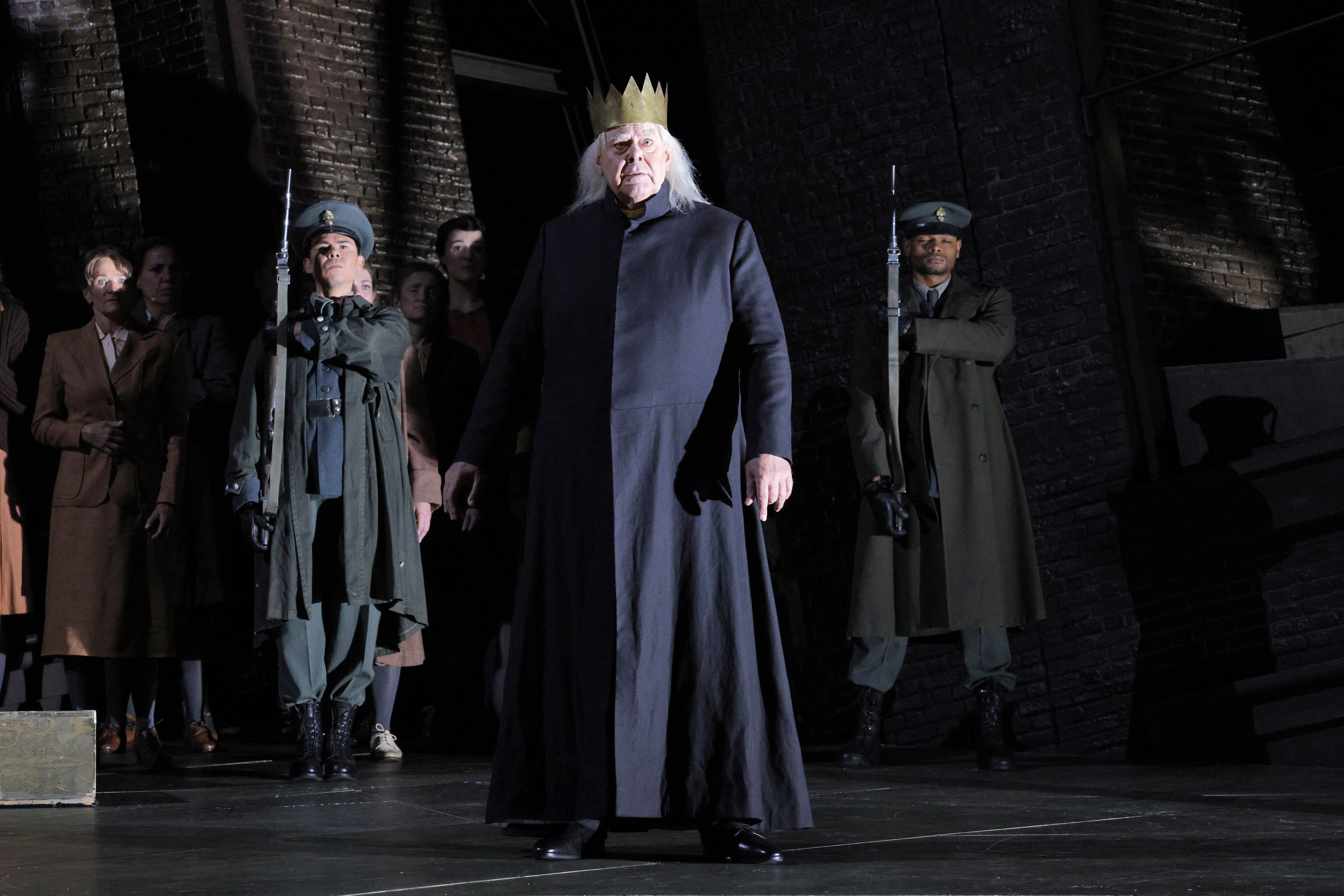King standing in front guards singing