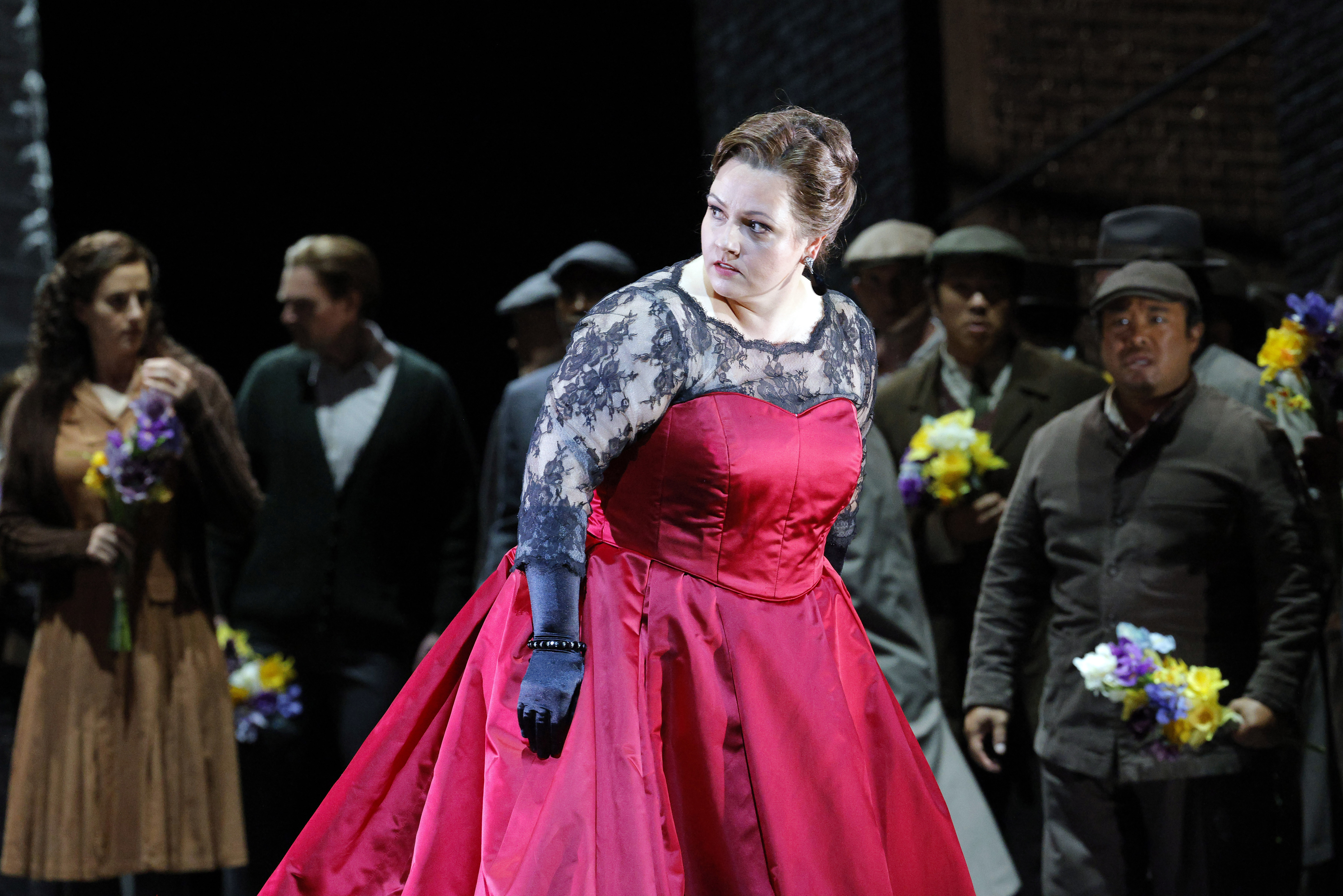 women in red dress looking over her right shoulder